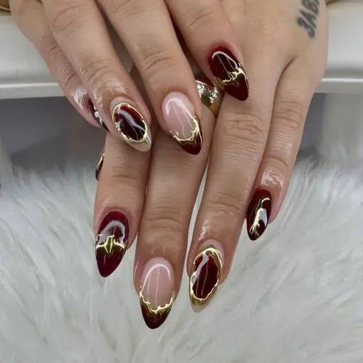 Burgundy manicure with gold details